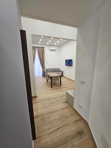 a living room with a table and a couch at Toto e Peppino Luxury Rooms in Naples