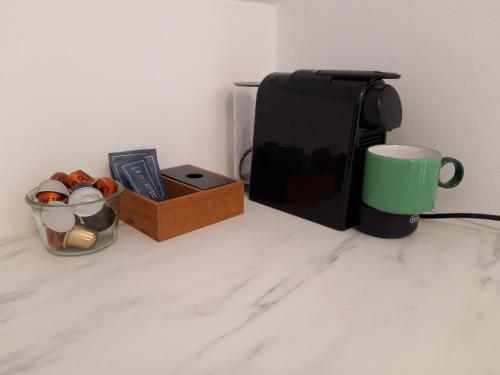 a coffee maker and a cup on a counter at Krogsgaarden B&B in Nibe