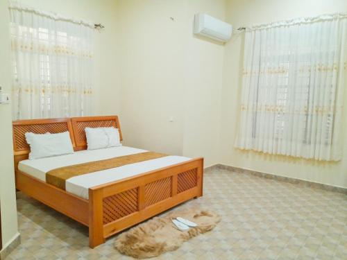 a bedroom with a bed in a room at Hellen's Riverside villas in Moshi