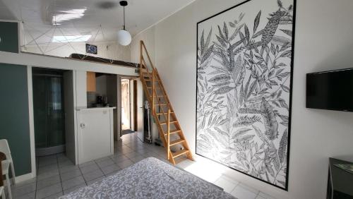 a room with a staircase and a mural on the wall at "Le studio" in Mouilleron-le-Captif