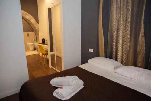Postel nebo postele na pokoji v ubytování Vicolo delle Belle Suite