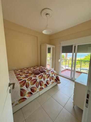 a bedroom with a bed and a balcony at Sea View Maison - Nea Potidea - Chalkidiki in Nea Potidaea