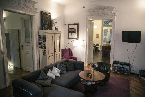 a living room with a couch and a table at Baroque Hostel & Coworking in Budapest