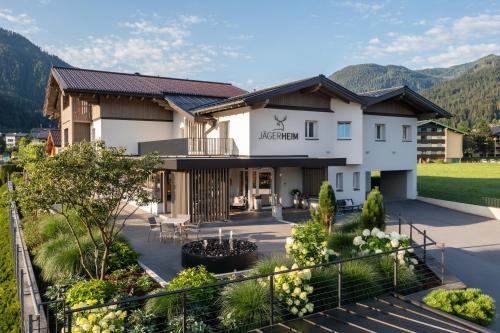 a view of a hotel with mountains in the background at Aparthotel Jägerheim in Flachau