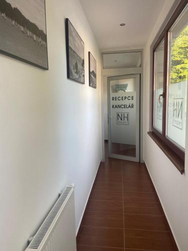 a hallway with a staircase with a sign on the wall at NH resort in Frýdek-Místek