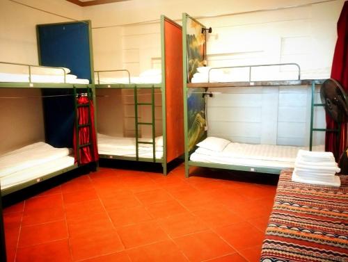 a room with three bunk beds in a room at Daun Pisang Homestay & Halal Food in Sapa