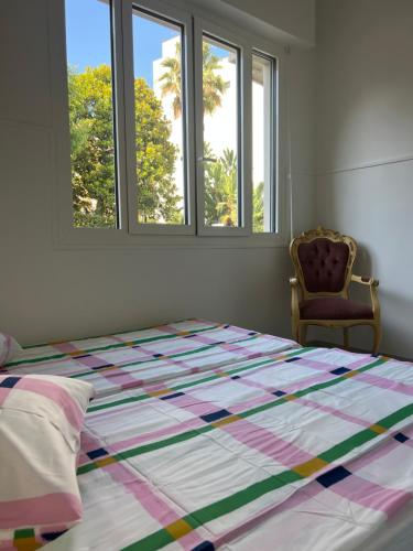 une chambre avec un lit avec une couette dessus dans l'établissement Long stay nearby Mariottes H Nice town, à Nice