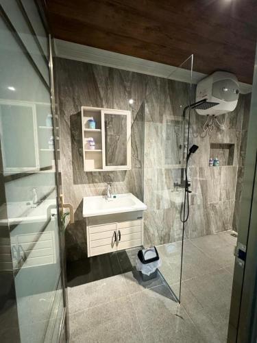 a bathroom with a sink and a shower at Villa Sibolangit Satu Hati near Hillpark with private pool in Bandarbaru
