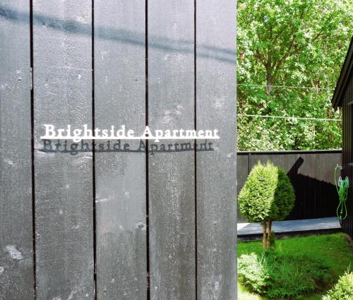a sign on the side of a building at Brightside Apartment in Kristiansand