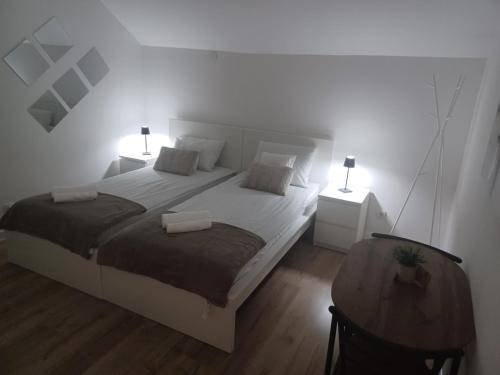 a bedroom with two beds and two night stands at Infinity app 2024 in Beli Manastir