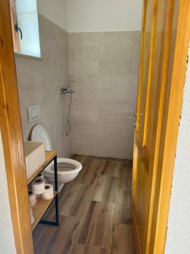 a bathroom with a toilet and a sink at Guest house SARA in Čapljina
