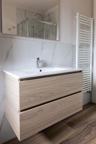 a bathroom with a sink and a mirror at Appartamenti Del Borgo in Borgosesia