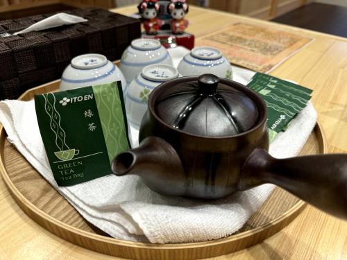 a tea pot sitting on a tray on a table at VILLA East West in Nara