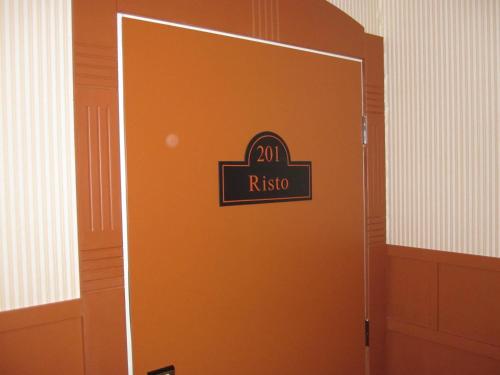 an orange door with a sign that reads rko on it at Hotelli-Ravintola Alma in Seinäjoki