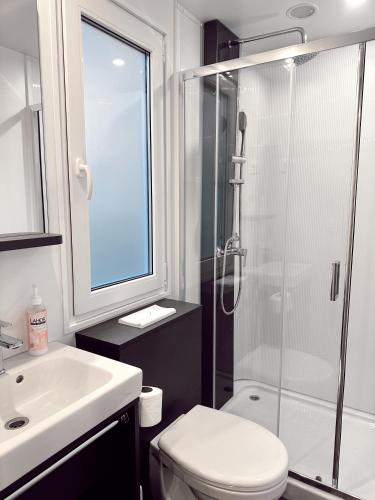 a bathroom with a shower and a toilet and a sink at Dream Escape Mobile Home in Vodice