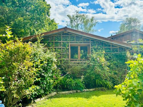 a house with a garden in front of it at Hideaway in Lytchett Matravers