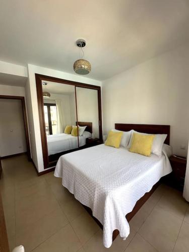 a bedroom with a bed and a large mirror at Residencial Noray Duplex 26 in Puerto Calero