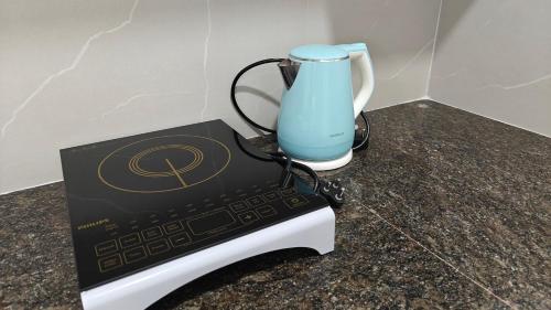 a remote control sitting on a counter with a vase at 116 Home Tales by Tipiverse, BTM Layout - NO CAR PARKING in Bengaluru