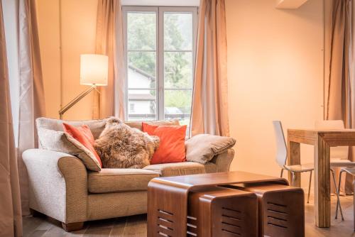 a living room with a couch and a window at Dependance Ost in Interlaken