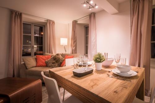 a living room with a table and a couch at Dependance Ost in Interlaken