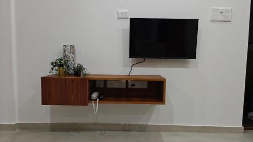 a flat screen tv hanging on a wall at 116 Home Tales by Tipiverse, BTM Layout - NO CAR PARKING in Bengaluru
