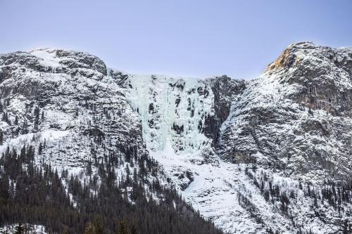 a waterfall on the side of a snow covered mountain at Modern cabin, great view, sunny, 2BA, 4BR in Hemsedal