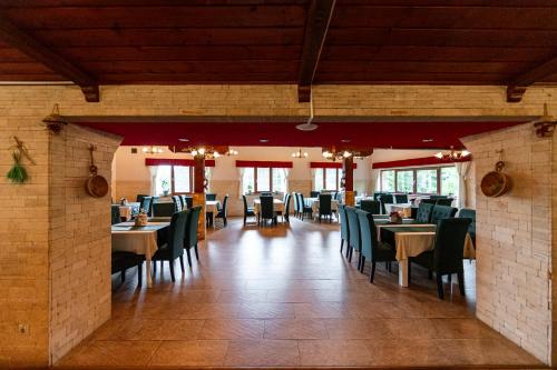 a restaurant with tables and chairs in a room at Resort EuroPark Fundata in Fundata
