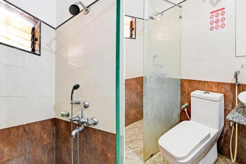 a bathroom with a toilet and a shower at Hotel O Home Bm-x in Khandagiri