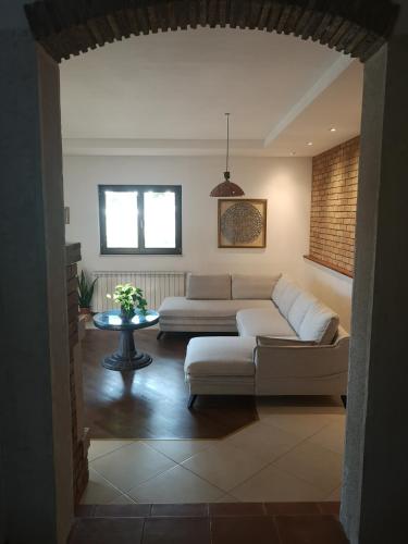 a living room with a couch and a table at Vila Magnolia in Vilanija