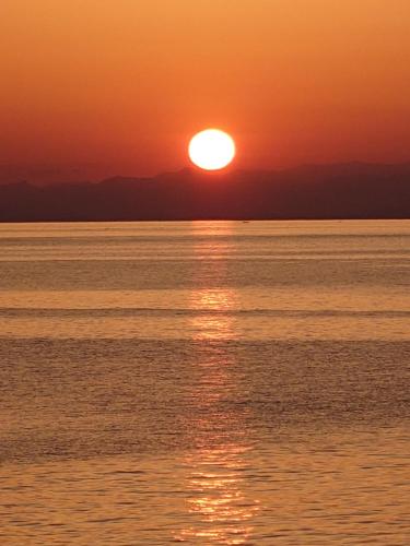 a sunset over the ocean with the sun setting at Super Pilgrimage Inn Karyogo A Private Retreat Just for You in Nahari