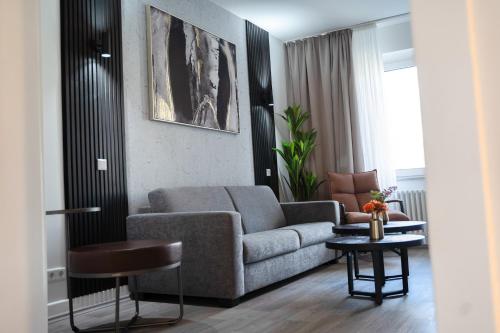 a living room with a couch and a table at JUNIK Apartments Oberhausen No º11 in Oberhausen