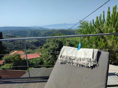 a towel hanging on a balcony with a view at Pacithea Villas in Miléai