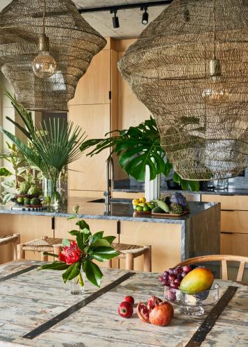 a kitchen with a table with fruit on it at Okulus Madeira in Funchal