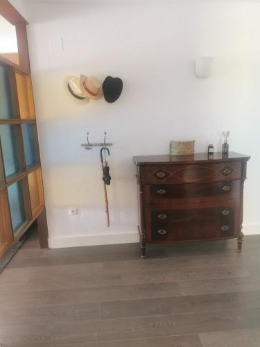 a room with a dresser and a hat on the wall at APARTAMENTO SOL Y MAR Primera Linea in Playa de Gandia