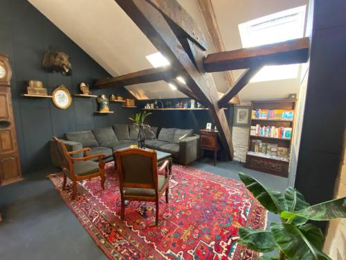 a living room with a couch and a table and chairs at Vakantiehuis 'Beim Mulles' in Vianden