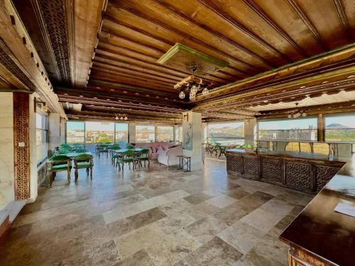 a large room with tables and chairs and windows at İncebey Konak Cappadocia in Uçhisar