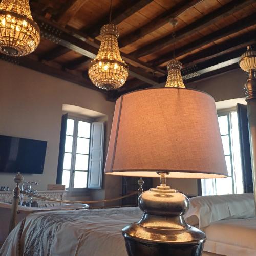 a lamp sitting on top of a bed with lights at Palazzo Boyl 1840 in Cagliari