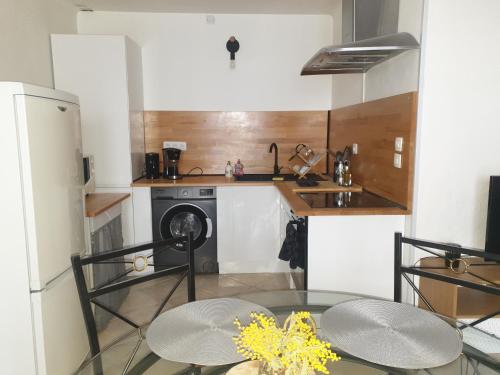 une petite cuisine avec une table et une cuisinière dans l'établissement appartement Saint Raphael Boulouris, à Saint-Raphaël