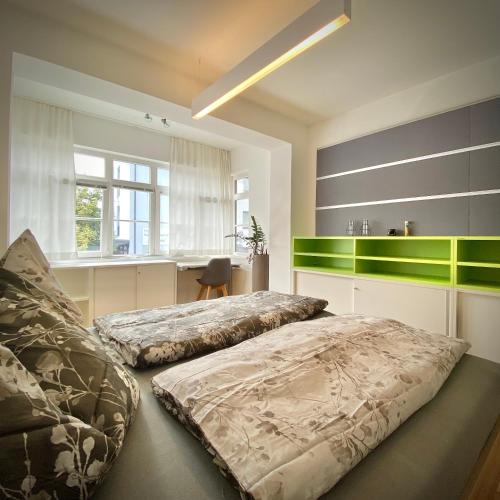 a bedroom with two beds and a desk in it at ROSA Wohnen & home office in traditionell Ausseer Baukultur in Bad Mitterndorf