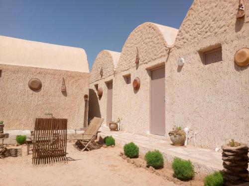 a courtyard of a building in the desert at Dar alibaba in Douz