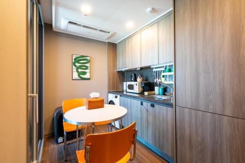 a small kitchen with a small table and a table and chairs at High floor view accommodation in Busan