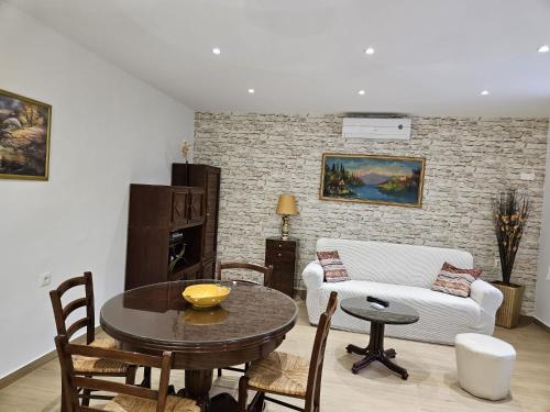 a living room with a table and a couch at Villa NIKA & KARLO Makarska in Makarska
