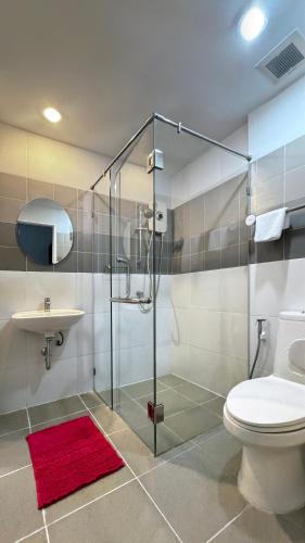a bathroom with a shower and a toilet and a sink at Vi Stay in Phuket
