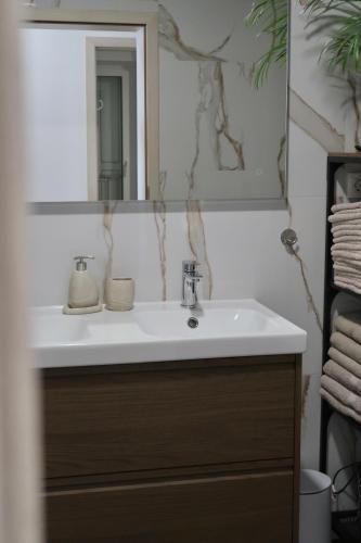 a bathroom with a sink and a mirror at Art Villa Malija in Portorož