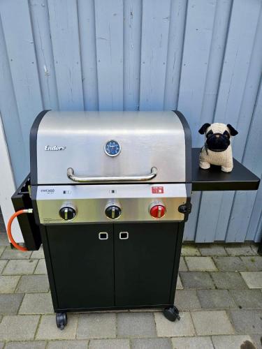 a grill with a pug dog sitting on top of it at HeideFunHaus 2 in Neuenkirchen