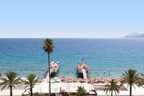 a group of people in the water at a beach at Mer du Sud 4 YourHostHelper in Cannes