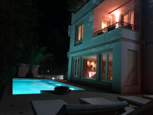 a house with a swimming pool at night at Villa LIDSON in Golem