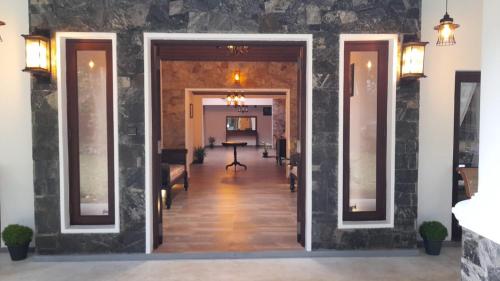a hallway leading to a living room with a table at Villa D55 in Kandy