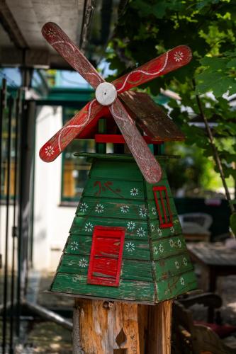 a green and red bird house with a propellor on it at Landhaus Hotel Wolfratshausen in Wolfratshausen