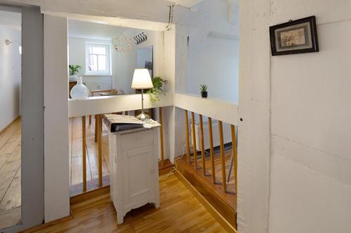 a room with a desk and a hallway with a staircase at Ferienwohnung Omi Anni in Schlitz